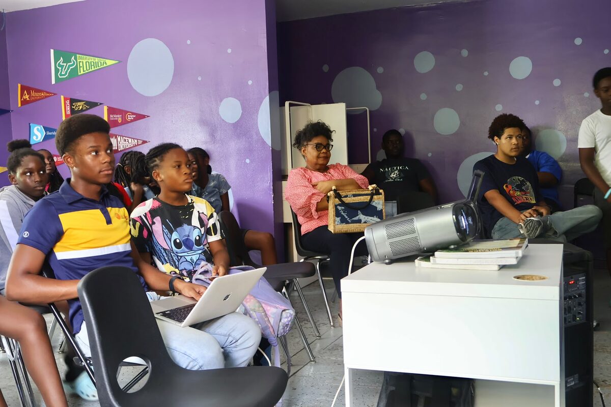 Boost Academy students following an interactive session with laptops and projector setup