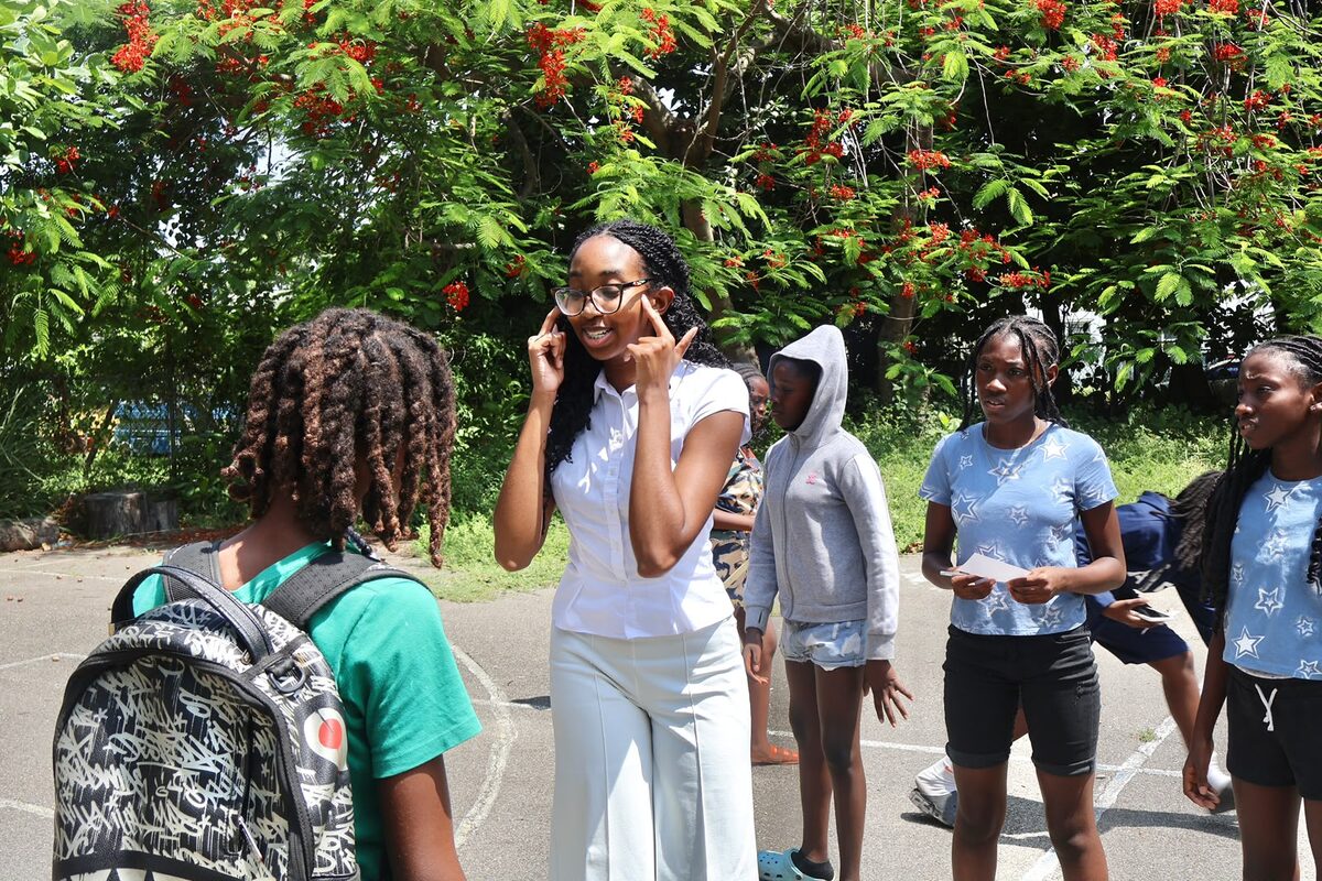 A facilitator leads Boost Academy students through an outdoor activity