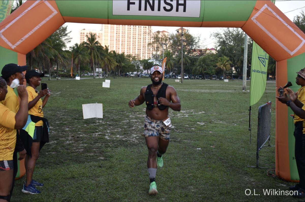 A participant sprints through the finish arch at the BAA Fun Run Walk