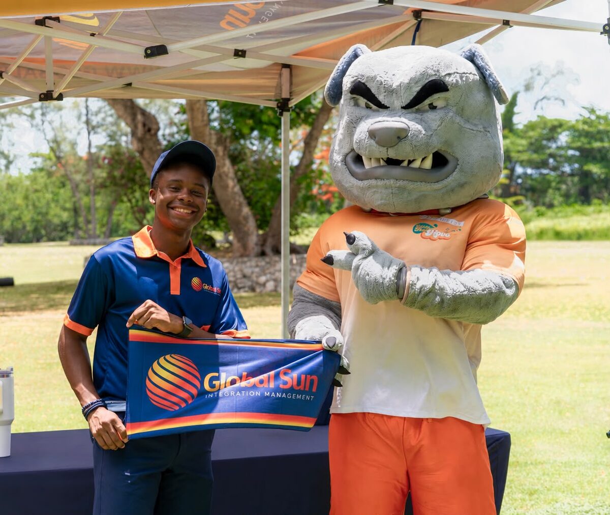 A Global Sun Integration team member with the event mascot at the tournament tent
