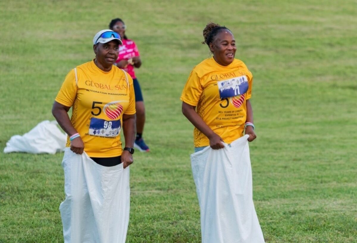 Team members take part in a sack race at the 5K The Jay Way field games