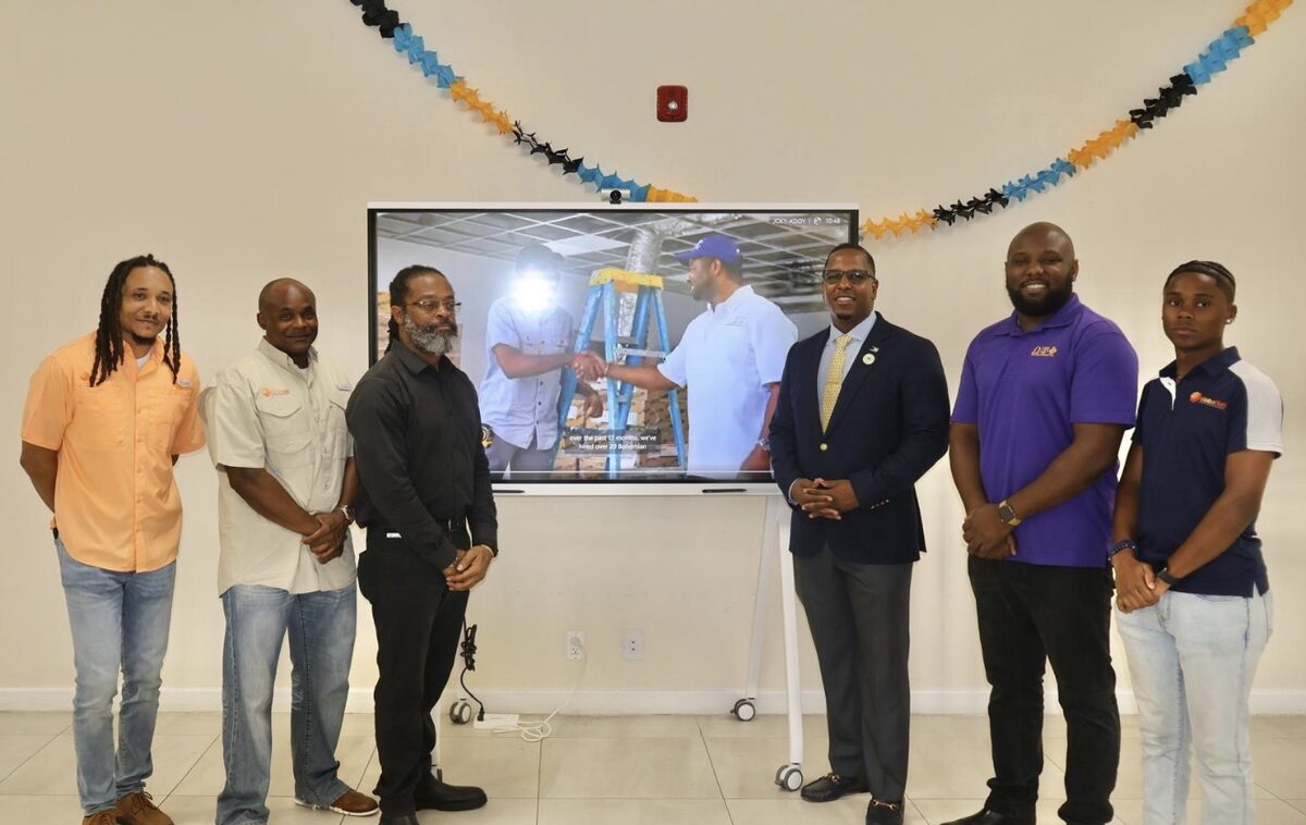 Representatives of Global Sun Integration, the Ministry of National Security, MP Jamahl Strachan and the Pi Psi Chapter of Omega Psi Phi Fraternity at the Nassau Village Community Centre handover