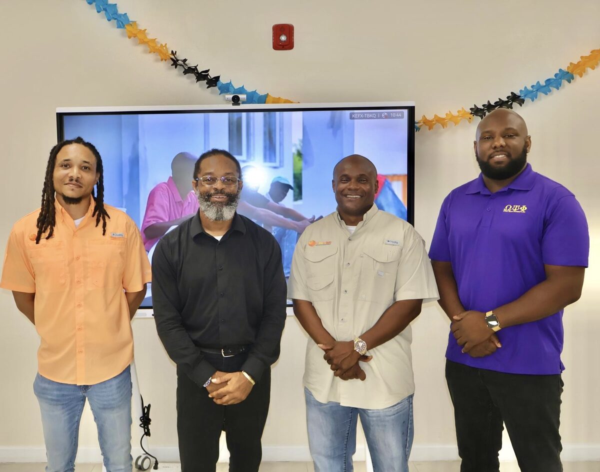 The Global Sun Integration team with a representative of the Pi Psi Chapter of Omega Psi Phi Fraternity